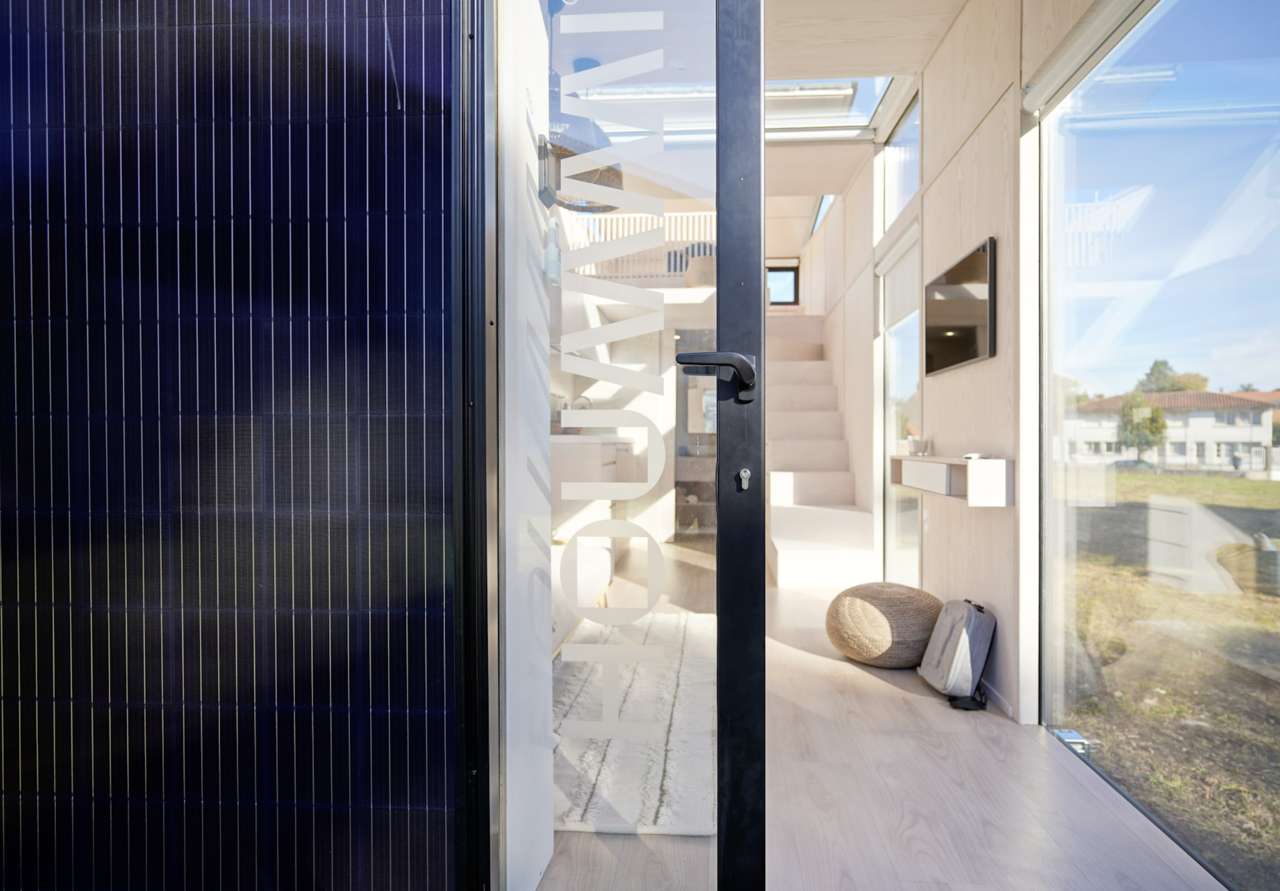 Entrée d'un module Hoummi, panneau photovoltaïque en façade et escalier vers la mezzanine