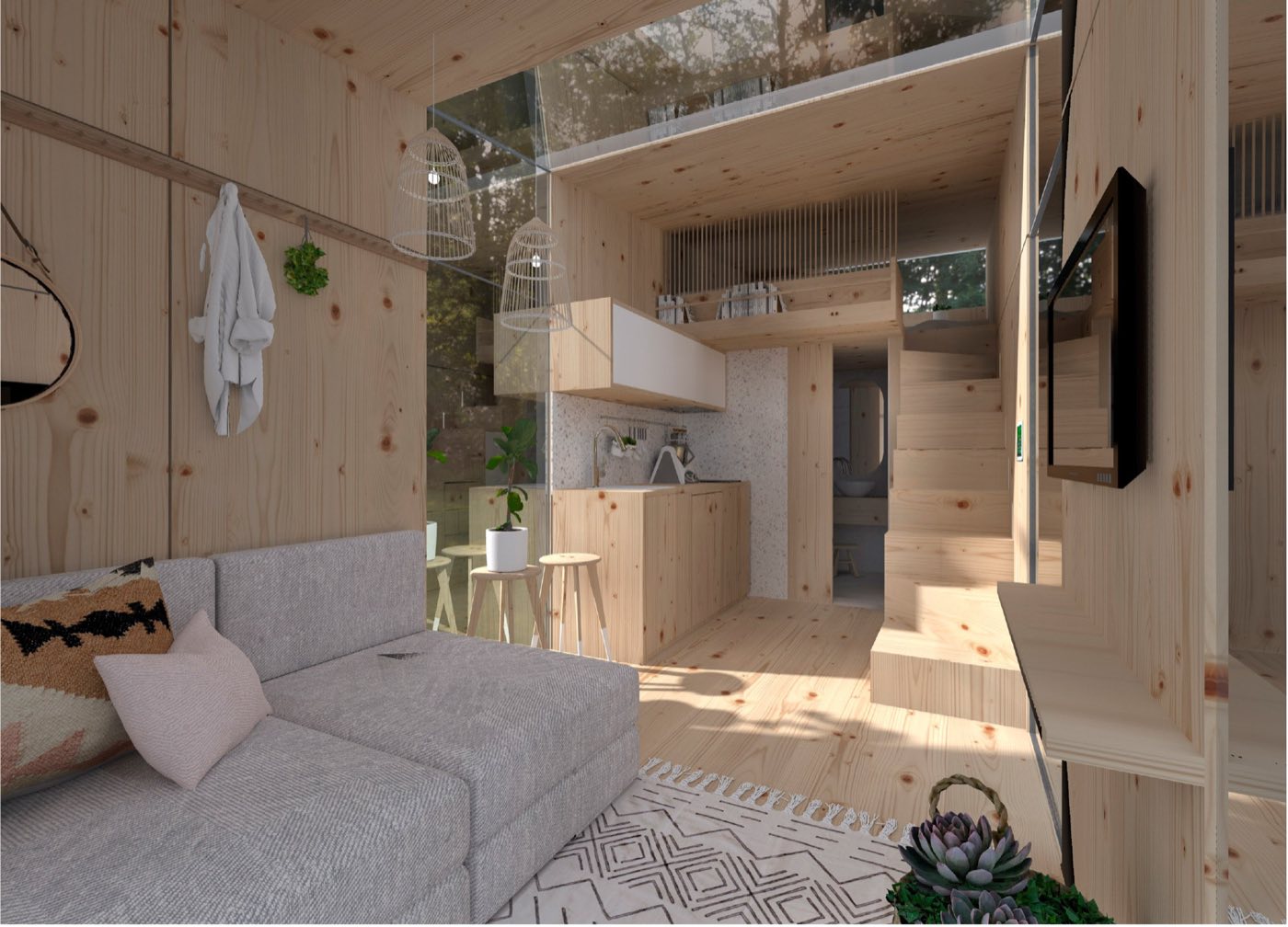 Intérieur tout bois : canapé d'angle, cuisine compacte et escalier vers la mezzanine